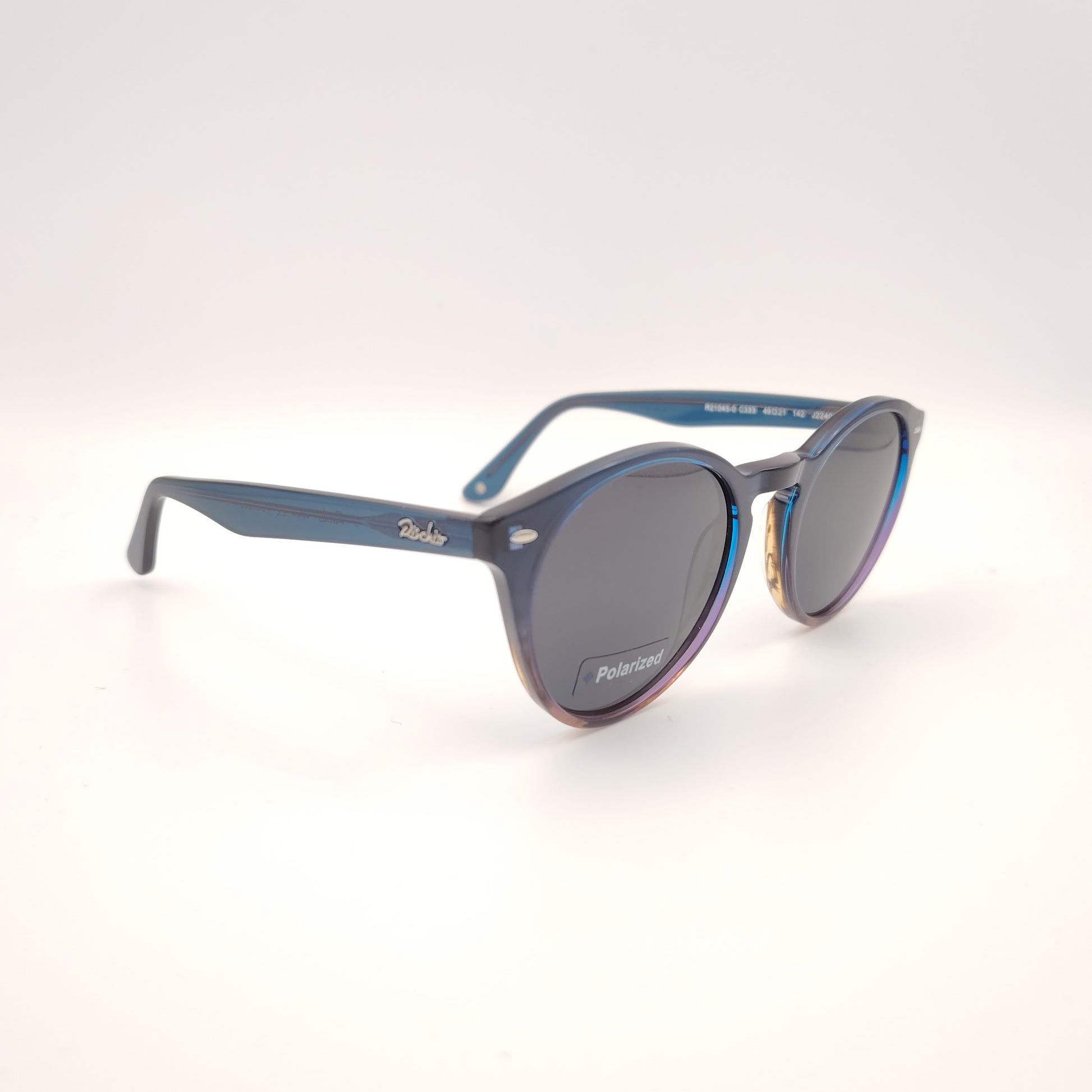 gafas de sol rischio r21043  c333 redondas de color azul y marrón con lentes polarizadas oscuras