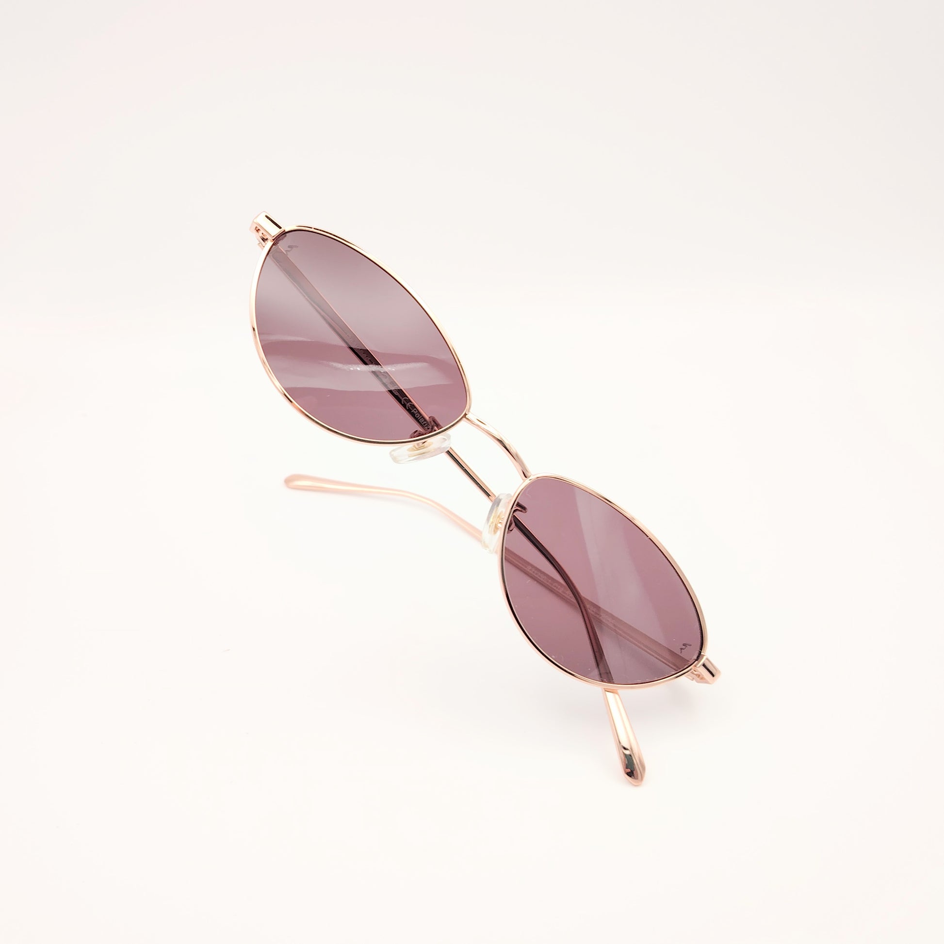 gafas de sol polarizadas rischio r21250 c14 con montura metálica oro rosado y lentes oscuras ovaladas