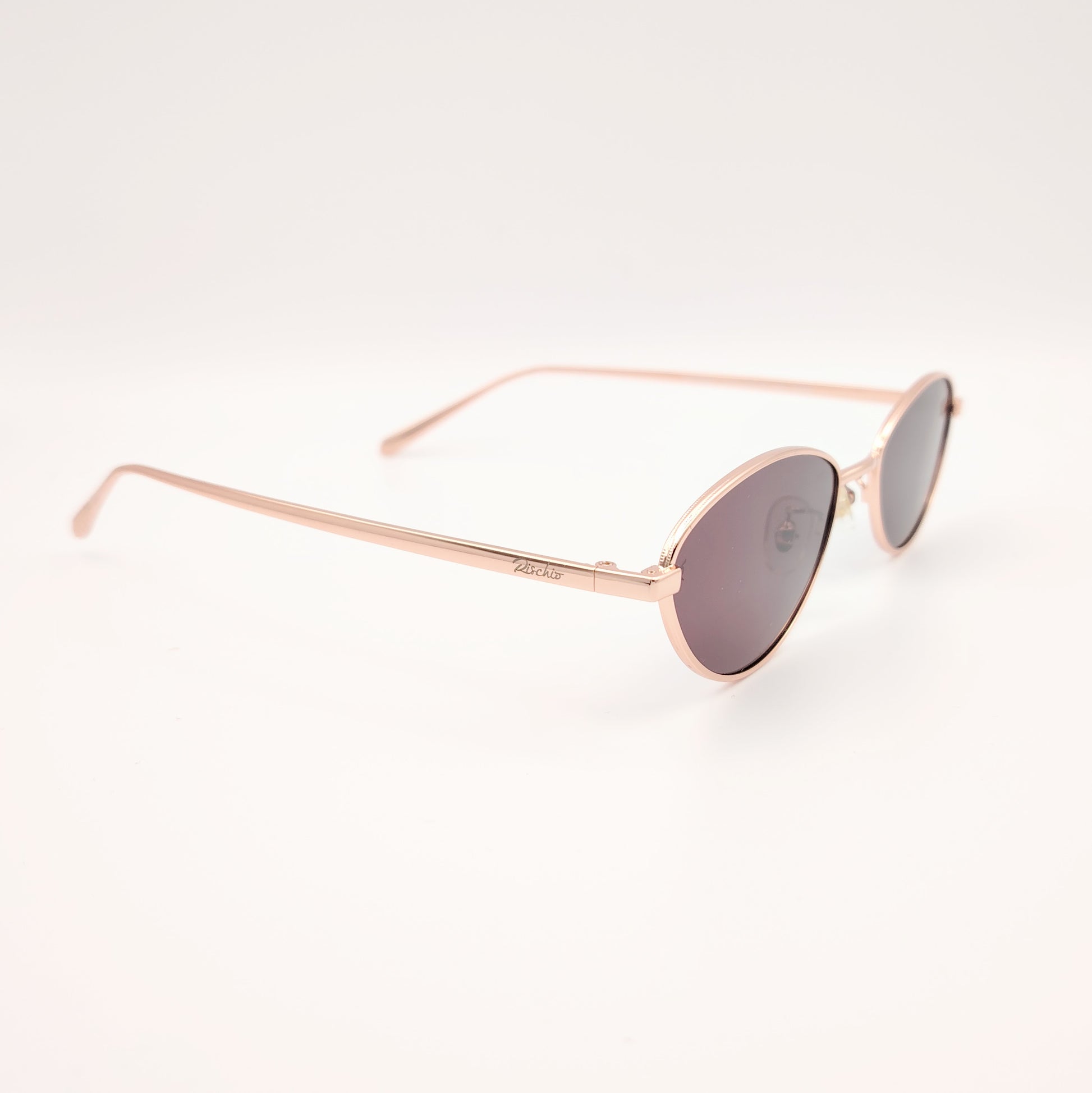 gafas de sol polarizadas rischio r21250 c14 con montura metálica oro rosado y lentes oscuras ovaladas