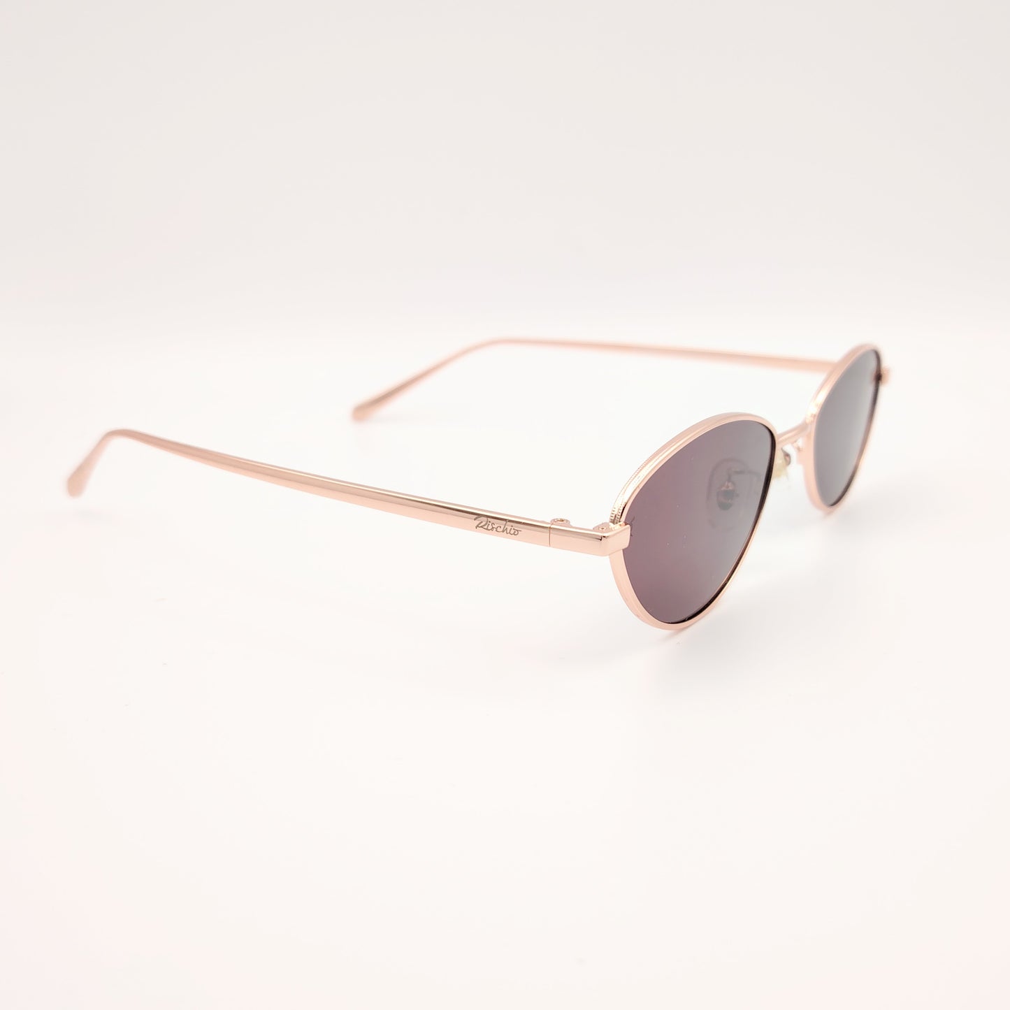 gafas de sol polarizadas rischio r21250 c14 con montura metálica oro rosado y lentes oscuras ovaladas